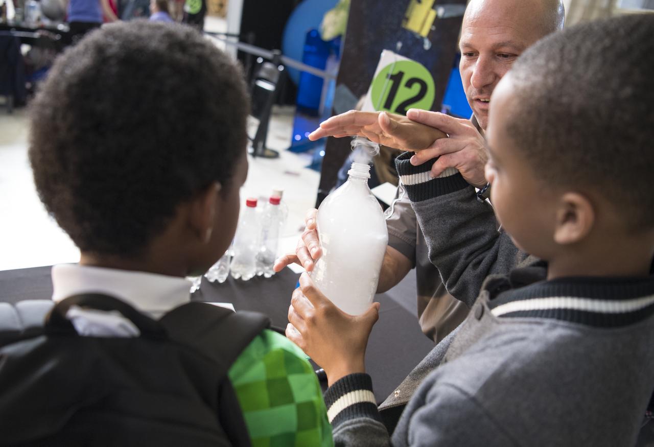 Students create a cloud in a bottle at one of NASA's exhibits at the Earth Day event on Monday, April 22, 2019, at Union Station in Washington, D.C. Photo Credit: (NASA/Joel Kowsky)