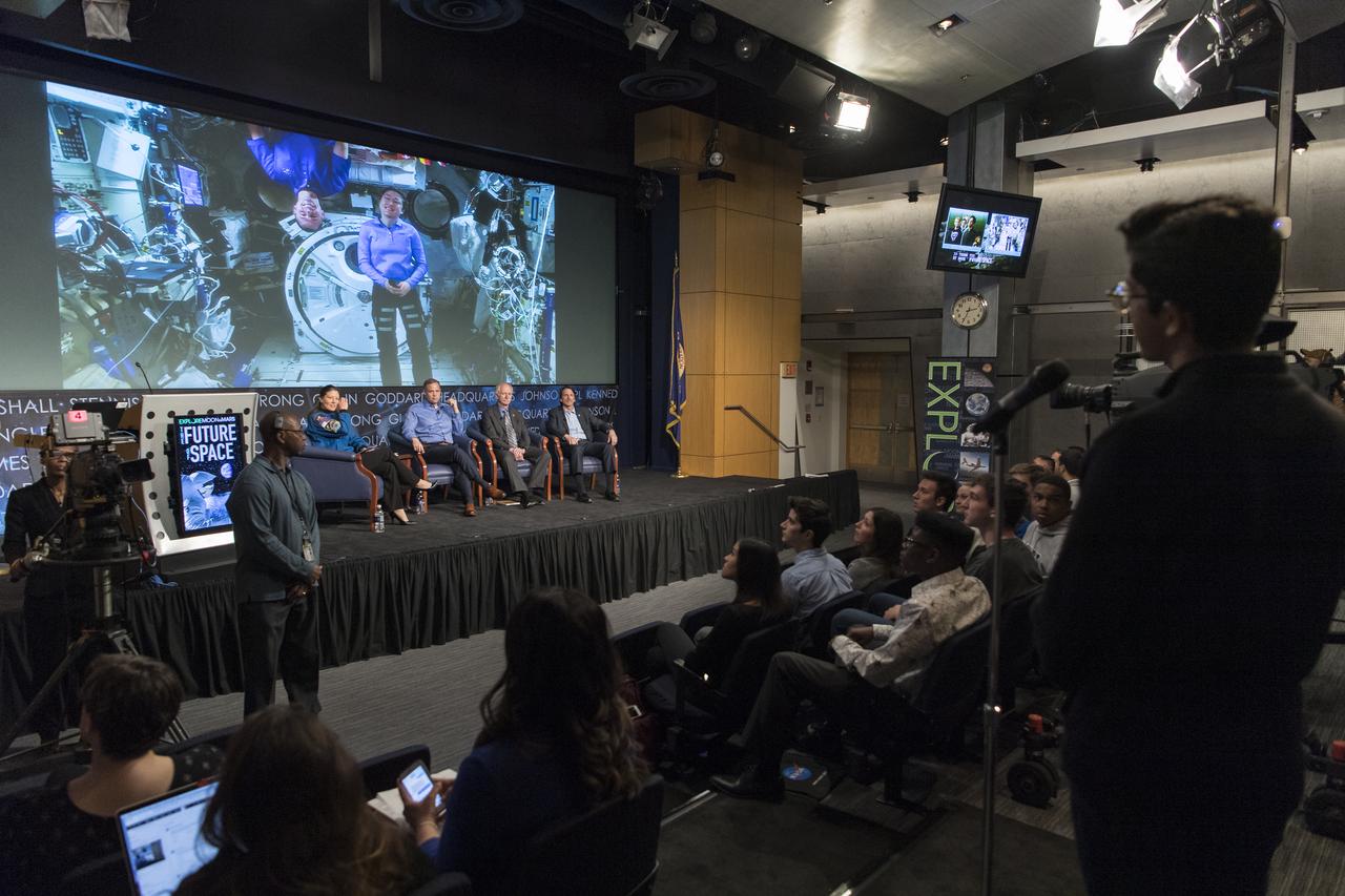 A student asks Nick Hague and Christina Koch, two astronauts currently living and working on the International Space Station, a question during a panel discussion with NASA Administrator Jim Bridenstine, NASA Associate Administrator for the Human Exploration and Operations Mission Directorate, Bill Gerstenmaier, and NASA Deputy Associate Administrator for Exploration, Steve Clarke at the "Future of Space" STEM event, Monday, April 29, 2019 at NASA Headquarters in Washington. NASA astronaut Tracy Caldwell Dyson, moderated the panel discussion. Photo Credit: (NASA/Aubrey Gemignani)