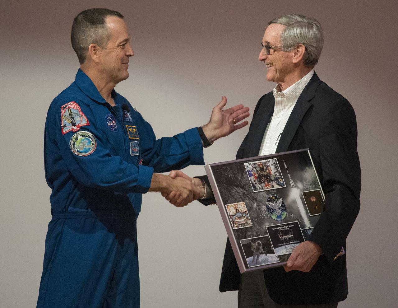 NASA astronaut Ricky Arnold presents Robert Gabrys, director of the Office fo STEM Engagement at NASA’s Goddard Space Flight Center, a montage from his mission onboard the International Space Station, Thursday, May 2, 2019 at NASA’s Goddard Space Flight Center in Greenbelt, Md. During Arnold’s 197 days onboard the International Space Station, as part of Expeditions 55 and 56, he ventured outside the space station on three spacewalks in addition to conducting numerous experiments and educational downlink events. Photo Credit: (NASA/Joel Kowsky)