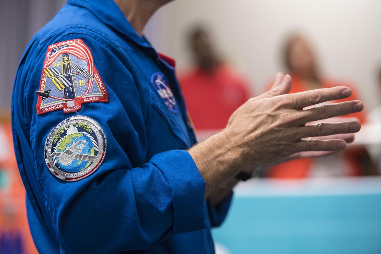 NASA astronaut Ricky Arnold speaks about his time onboard the International Space Station (ISS) during Expeditions 55 and 56, Friday, May 3, 2019 at the Challenger Center in Lanham, MD. During Expedition 55/56, Arnold completed three spacewalks for a total of 19.5 hours outside the space station, and concluded his 197 day mission when he landed in a remote area near the town of Zhezkazgan, Kazakhstan in Oct. 2018. He also flew to the space station on shuttle mission STS-119 to deliver the final pair of power-generating solar array wings. Photo Credit: (NASA/Aubrey Gemignani)