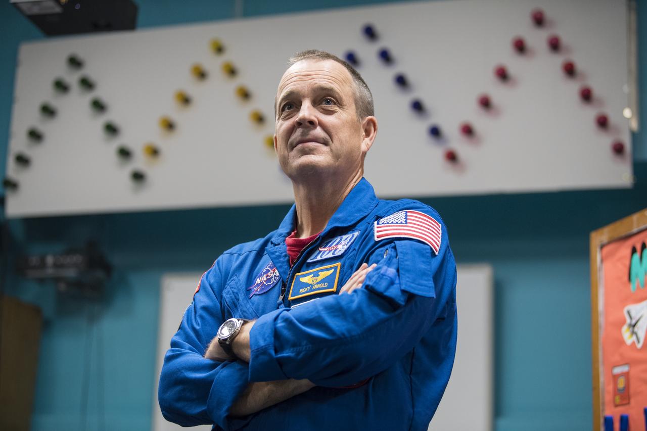 NASA astronaut Ricky Arnold is seen during a talk about his time onboard the International Space Station (ISS) during Expeditions 55 and 56, Friday, May 3, 2019 at the Challenger Center in Lanham, MD. During Expedition 55/56, Arnold completed three spacewalks for a total of 19.5 hours outside the space station, and concluded his 197 day mission when he landed in a remote area near the town of Zhezkazgan, Kazakhstan in Oct. 2018. He also flew to the space station on shuttle mission STS-119 to deliver the final pair of power-generating solar array wings. Photo Credit: (NASA/Aubrey Gemignani)