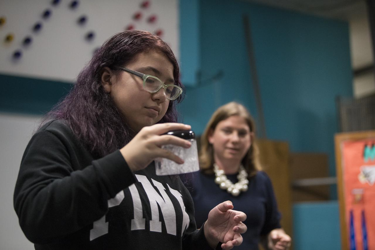 A student shakes a glass of water with an Alka-Seltzer tab in it while conducting an experiment on effervescence, Friday, May 3, 2019 at the Challenger Center in Lanham, MD. NASA astronaut Ricky Arnold helped them carry out the experiment which he also conducted during his 197 day mission onboard the International Space Station (ISS) during Expeditions 55/56. Photo Credit: (NASA/Aubrey Gemignani)