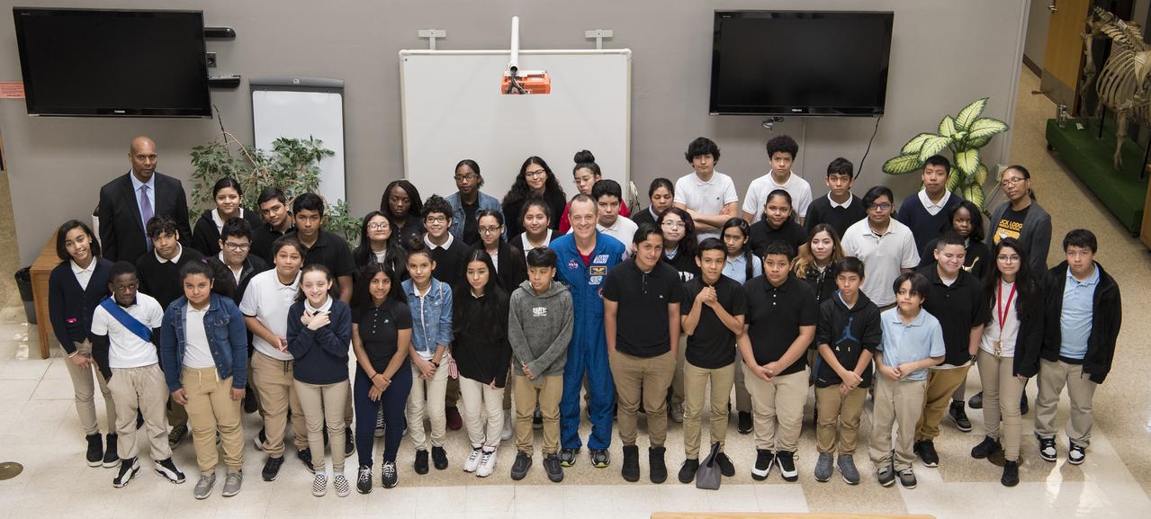 NASA astronaut Ricky Arnold poses for a photo with students after speaking with them about his time onboard the International Space Station (ISS) during Expeditions 55 and 56, Friday, May 3, 2019 in Lanham, MD. During Expedition 55/56, Arnold completed three spacewalks for a total of 19.5 hours outside the space station, and concluded his 197 day mission when he landed in a remote area near the town of Zhezkazgan, Kazakhstan in Oct. 2018. He also flew to the space station on shuttle mission STS-119 to deliver the final pair of power-generating solar array wings. Photo Credit: (NASA/Aubrey Gemignani)