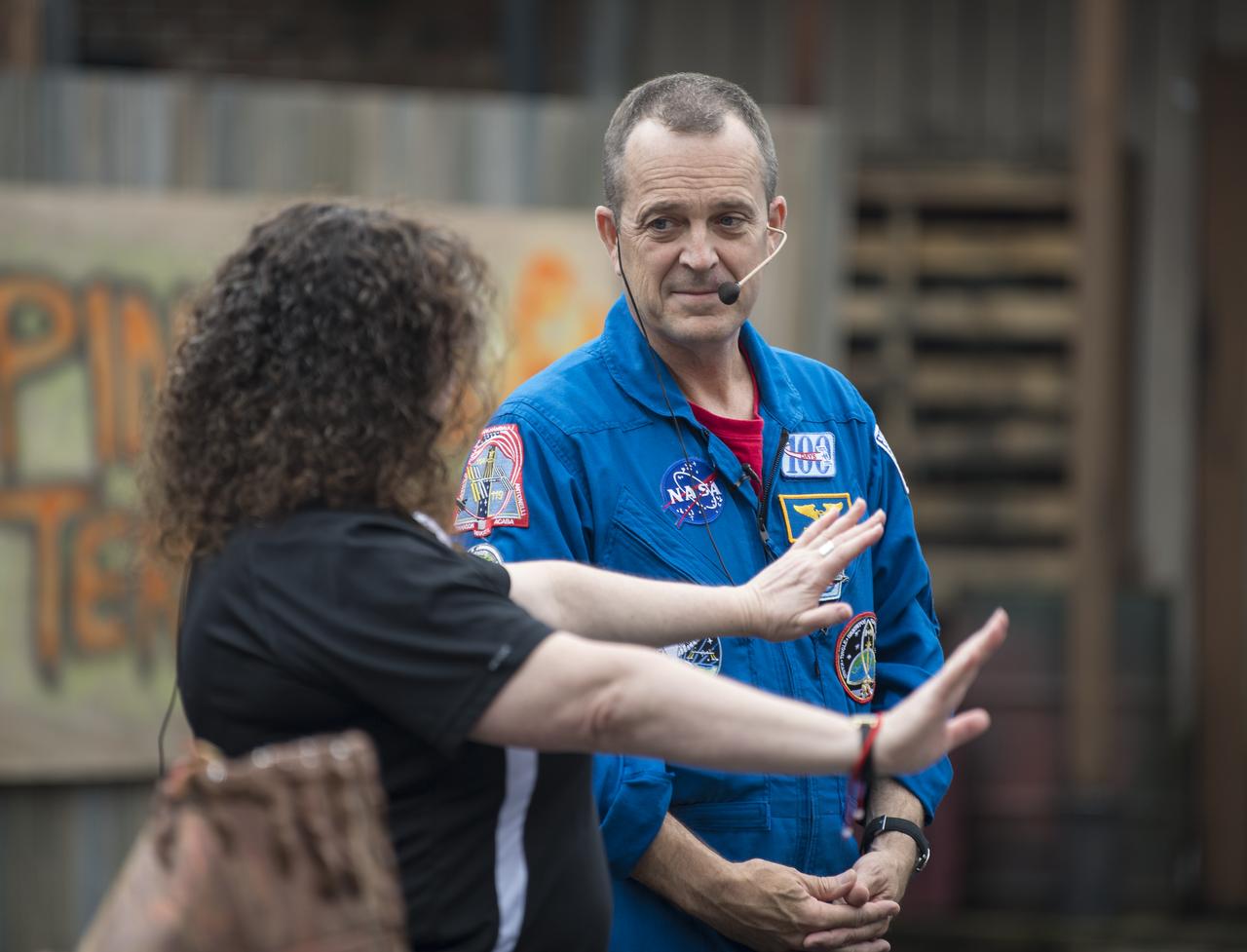 NASA astronaut Ricky Arnold speaks with Beth Wilson of  Smithsonian National Air and Space Museum's Stem in 30 production, Friday, May 3, 2019 at Six Flags America theme park in Upper Marlboro, MD. During Expedition 55/56, Arnold completed three spacewalks for a total of 19.5 hours outside the space station, and concluded his 197 day mission when he landed in a remote area near the town of Zhezkazgan, Kazakhstan in Oct. 2018. He also flew to the space station on shuttle mission STS-119 to deliver the final pair of power-generating solar array wings. Photo Credit: (NASA/Aubrey Gemignani)