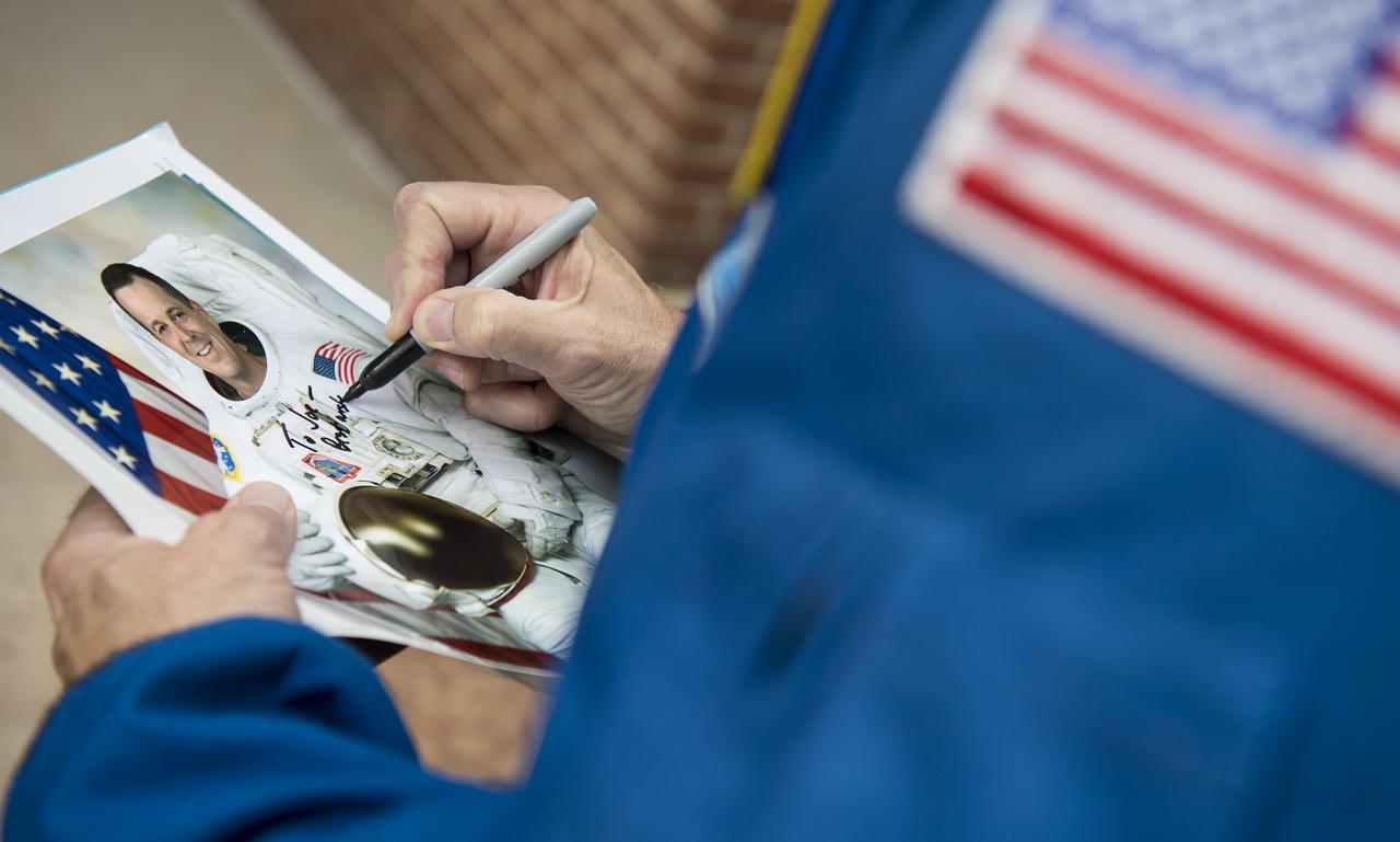 NASA astronaut and Maryland native Ricky Arnold signs an autograph before the Tampa Bay Rays take on the Baltimore Orioles, Saturday, May 4, 2019 at Camden Yards in Baltimore, Md. During Arnold’s 197 days onboard the International Space Station, as part of Expeditions 55 and 56, he ventured outside the space station on three spacewalks in addition to conducting numerous experiments and educational downlink events. Photo Credit: (NASA/Joel Kowsky)
