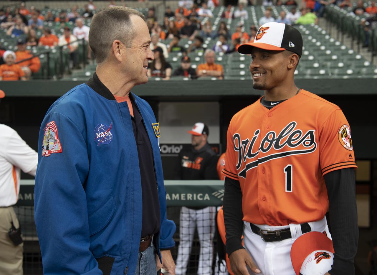 NASA astronaut and Maryland native Ricky Arnold talks with Baltimore Orioles shortstop Richie Martin before the Tampa Bay Rays take on the Baltimore Orioles, Saturday, May 4, 2019 at Camden Yards in Baltimore, Md. During Arnold’s 197 days onboard the International Space Station, as part of Expeditions 55 and 56, he ventured outside the space station on three spacewalks in addition to conducting numerous experiments and educational downlink events. Photo Credit: (NASA/Joel Kowsky)