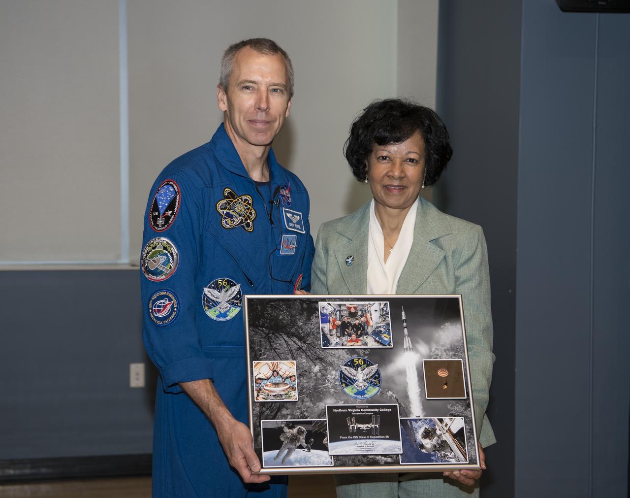 NASA astronaut Drew Feustel, left, poses for a photo with Northern Virginia Community College's Alexandria campus provost, Dr. Annette Haggray, after presenting her with a montage from Expeditions 55 and 56, Monday, May 6, 2019 in Virginia. Photo Credit: (NASA/Aubrey Gemignani)