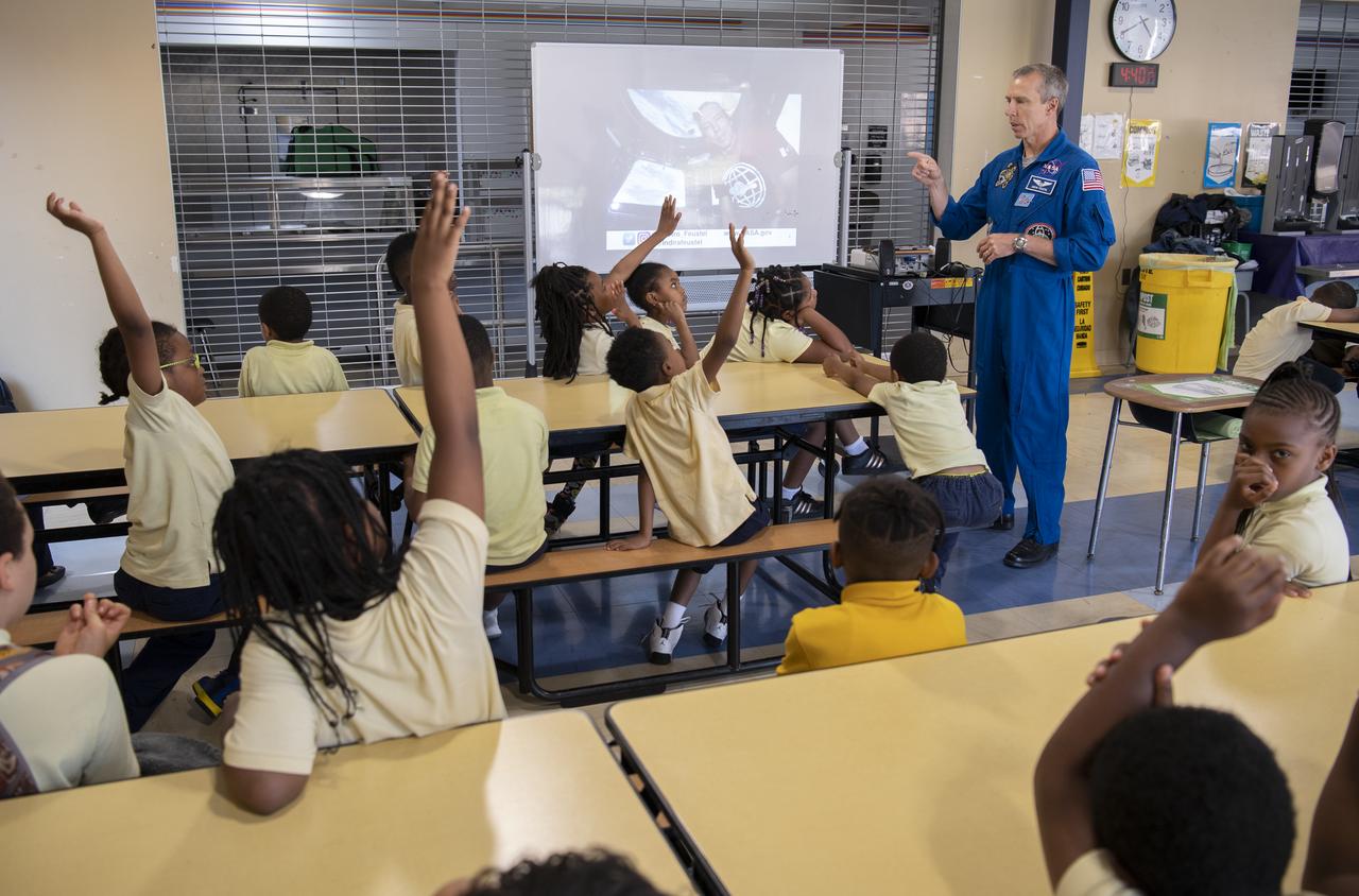 NASA astronaut Drew Feustel speaks to students at John Burroughs Elementary School about his experiences on two space shuttle missions, STS-125 and STS-134, and a long duration mission onboard the International Space Station, Tuesday, May 7, 2019 in Washington, DC. Feustel most recently spent 197 days living and working onboard the International Space Station as part of Expedition 55 and as commander of Expedition 56. Feustel ventured outside the space station on three spacewalks, moving him up to second among U.S. spacewalkers with a cumulative time of 61 hours 48 minutes over nine spacewalks. Photo Credit: (NASA/Joel Kowsky)