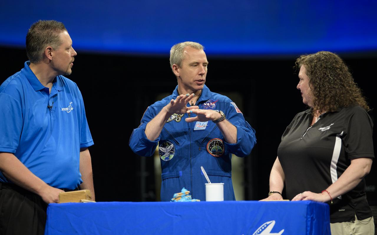 NASA astronaut Drew Feustel, center, talks about seismology while taping a segment of STEM in 30 with Marty Kelsey, left, and Beth Wilson, right, Thursday, May 9, 2019 at the Smithsonian’s National Air and Space Museum in Washington, DC. Feustel most recently spent 197 days living and working onboard the International Space Station as part of Expedition 55 and as commander of Expedition 56. Feustel ventured outside the space station on three spacewalks, moving him up to second among U.S. spacewalkers with a cumulative time of 61 hours 48 minutes over nine spacewalks. Photo Credit: (NASA/Joel Kowsky)