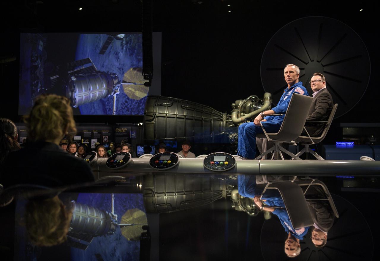 Smithsonian National Air and Space Museum curator Jeremy Kinney, right, and NASA astronaut Drew Feustel, left, are seen as a short video about Feustel’s mission to the International Space Station is shown during “What’s New in Aerospace,” Thursday, May 9, 2019 at the Smithsonian’s National Air and Space Museum in Washington, DC. Feustel most recently spent 197 days living and working onboard the International Space Station as part of Expedition 55 and as commander of Expedition 56. Feustel ventured outside the space station on three spacewalks, moving him up to second among U.S. spacewalkers with a cumulative time of 61 hours 48 minutes over nine spacewalks. Photo Credit: (NASA/Joel Kowsky)
