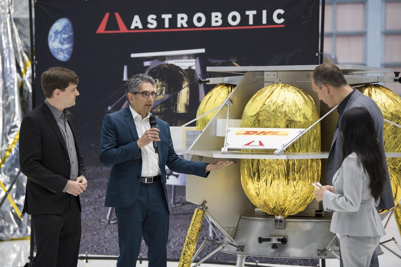 NASA Associate Administrator, Science Mission Directorate, Thomas Zurbuchen, second from right, speaks to Astrobotic CEO, John Thornton, left, and Astrobotic Mission Director, Sharad Bhaskaran, second from left, about their lunar lander, Friday, May 31, 2019, at Goddard Space Flight Center in Md. Astrobotic, Intuitive Machines, and Orbit Beyond have been selected to provide the first lunar landers for the Artemis program's lunar surface exploration. Photo credit: (NASA/Aubrey Gemignani)