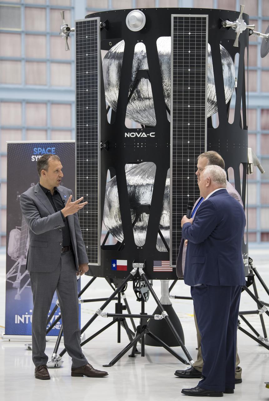 NASA Associate Administrator, Science Mission Directorate, Thomas Zurbuchen, left, speaks to, Chairman of the Board of Intuitive Machines, Kam Ghaffarian, right, and VP of Research and Development of Intuitive Machines, Tim Crain, second from right, about their lunar lander, Friday, May 31, 2019, at Goddard Space Flight Center in Md. Astrobotic, Intuitive Machines, and Orbit Beyond have been selected to provide the first lunar landers for the Artemis program's lunar surface exploration. Photo credit: (NASA/Aubrey Gemignani)