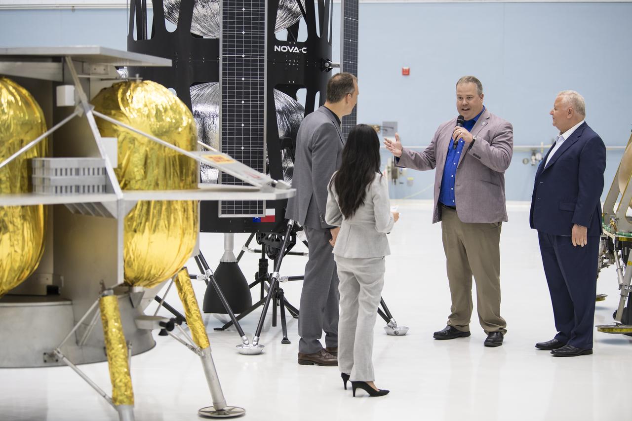 VP of Research and Development of Intuitive Machines, Tim Crain, second from right, speaks with NASA Associate Administrator, Science Mission Directorate, Thomas Zurbuchen, second from left, about their lunar lander, Friday, May 31, 2019, at Goddard Space Flight Center in Md. Astrobotic, Intuitive Machines, and Orbit Beyond have been selected to provide the first lunar landers for the Artemis program's lunar surface exploration. Photo credit: (NASA/Aubrey Gemignani)
