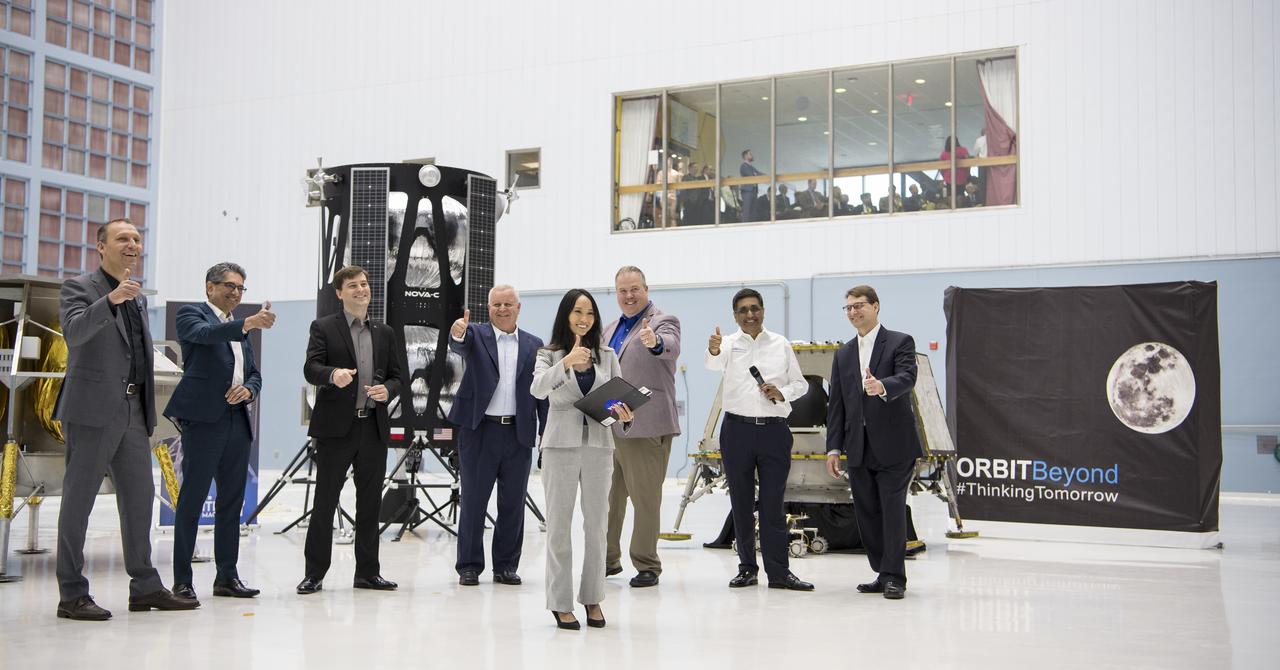 From left to right, NASA Associate Administrator, Science Mission Directorate, Thomas Zurbuchen; Astrobotic Mission Director, Sharad Bhaskaran; Astrobotic CEO, John Thornton; Chairman of the Board of Intuitive Machines, Kam Ghaffarian; VP of Research and Development of Intuitive Machines, Tim Crain; President and CEO of OrbitBeyond, Siba Padhi; Chief Science Officer, OrbitBeyond, Jon Morse;  and NASA Press Officer, Felicia Chou, front center, put their thumbs up at the conclusion of an event announcing the companies that will provide the first lunar landers for the Artemis program's lunar surface exploration, Friday, May 31, 2019, at Goddard Space Flight Center in Md. Photo credit: (NASA/Aubrey Gemignani)
