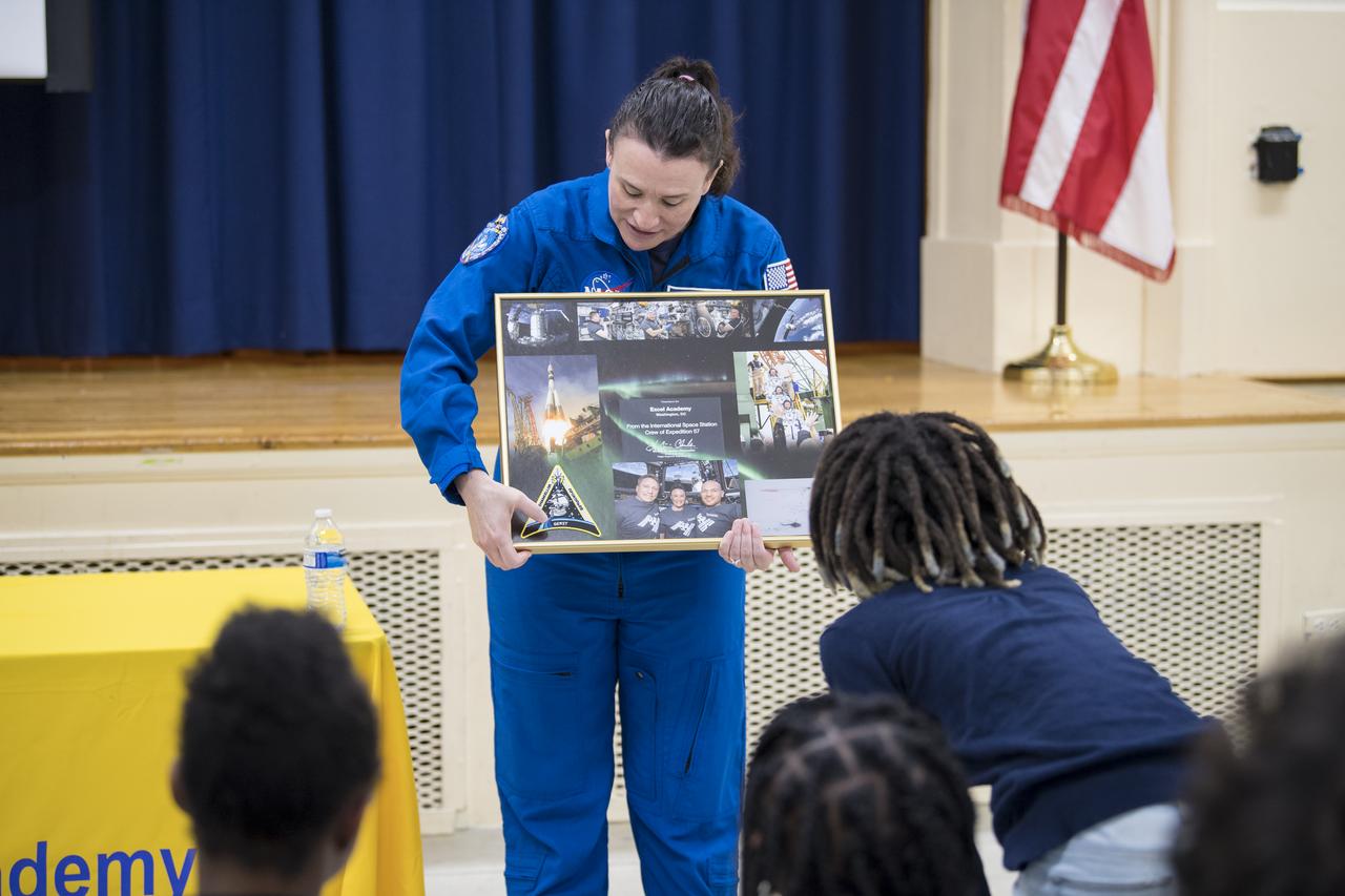 NASA astronaut Dr. Serena Auñón-Chancellor presents a montage from Expeditions 56 and 57 to the students of Excel Academy Public Charter School, Monday, June 10, 2019 in Washington, DC. Auñón-Chancellor spent 197 days living and working onboard the ISS and contributed to hundreds of experiments in biology, biotechnology, physical science, and Earth science while there. She is also a doctor and started her career with NASA as a flight surgeon in 2006. Photo Credit: (NASA/Aubrey Gemignani)