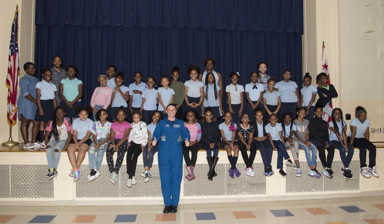 NASA astronaut Dr. Serena Auñón-Chancellor poses for a group photo after a presentation about her experience on Expeditions 56 and 57 onboard the International Space Station (ISS) at Excel Academy Public Charter School, Monday, June 10, 2019 in Washington, DC. Auñón-Chancellor spent 197 days living and working onboard the ISS and contributed to hundreds of experiments in biology, biotechnology, physical science, and Earth science while there. She is also a doctor and started her career with NASA as a flight surgeon in 2006. Photo Credit: (NASA/Aubrey Gemignani)