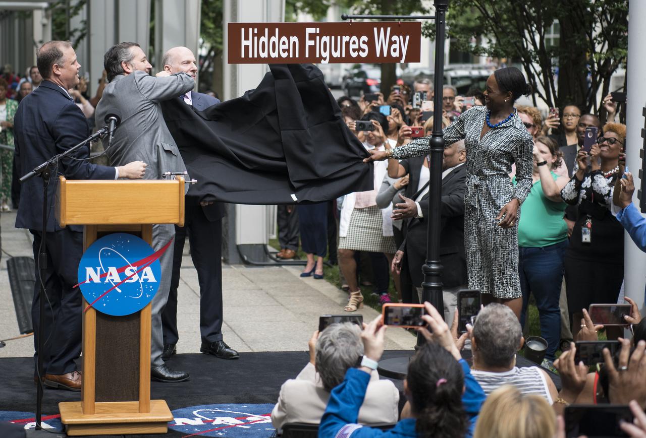 NASA Administrator Jim Bridenstine, left, U.S. Senator Ted Cruz, R-Texas, second from left, D.C. Council Chairman Phil Mendelson, third from left, and Margot Lee Shetterly, author of the book "Hidden Figures," right, unveil the "Hidden Figures Way" street sign at a dedication ceremony, Wednesday, June 12, 2019 at NASA Headquarters in Washington, DC. The 300 block of E Street SW in front of the NASA Headquarters building was designated as "Hidden Figures Way" to honor Katherine Johnson, Dorothy Vaughan, Mary Jackson and all women who have dedicated their lives to honorably serving their country, advancing equality, and contributing to the space program of the United States. Photo Credit: (NASA/Joel Kowsky)