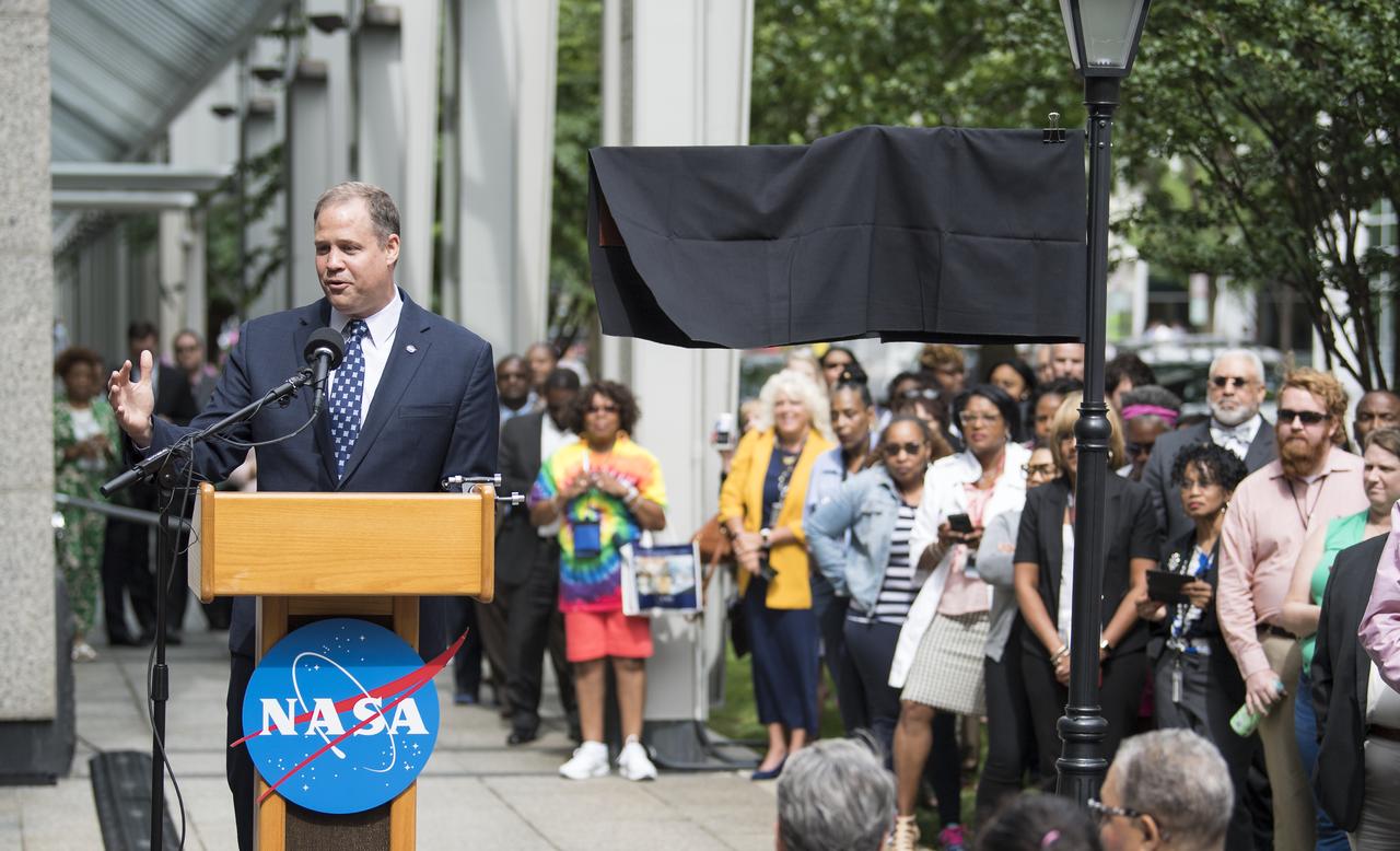 NASA Administrator Jim Bridenstine delivers remarks during the dedication ceremony for "Hidden Figures Way," Wednesday, June 12, 2019 at NASA Headquarters in Washington, DC. The 300 block of E Street SW in front of the NASA Headquarters building was designated as "Hidden Figures Way" to honor Katherine Johnson, Dorothy Vaughan, Mary Jackson and all women who have dedicated their lives to honorably serving their country, advancing equality, and contributing to the space program of the United States. Photo Credit: (NASA/Joel Kowsky)
