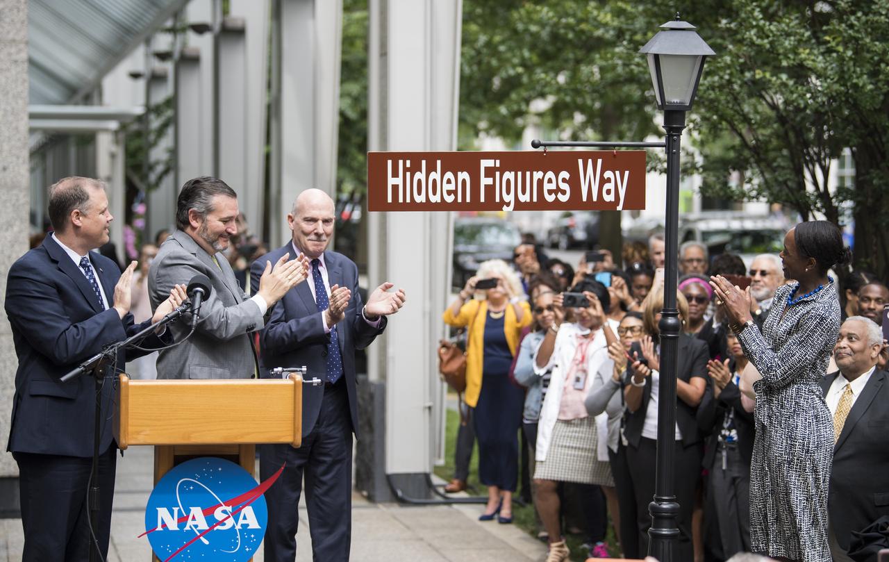 NASA Administrator Jim Bridenstine, left, U.S. Senator Ted Cruz, R-Texas, second from left, D.C. Council Chairman Phil Mendelson, third from left, and Margot Lee Shetterly, author of the book "Hidden Figures," right, unveil the "Hidden Figures Way" street sign at a dedication ceremony, Wednesday, June 12, 2019 at NASA Headquarters in Washington, DC. The 300 block of E Street SW in front of the NASA Headquarters building was designated as "Hidden Figures Way" to honor Katherine Johnson, Dorothy Vaughan, Mary Jackson and all women who have dedicated their lives to honorably serving their country, advancing equality, and contributing to the space program of the United States. Photo Credit: (NASA/Joel Kowsky)