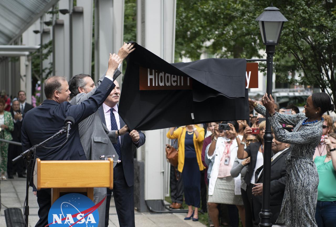 NASA Administrator Jim Bridenstine, left, U.S. Senator Ted Cruz, R-Texas, second from left, D.C. Council Chairman Phil Mendelson, third from left, and Margot Lee Shetterly, author of the book "Hidden Figures," right, unveil the "Hidden Figures Way" street sign at a dedication ceremony, Wednesday, June 12, 2019 at NASA Headquarters in Washington, DC. The 300 block of E Street SW in front of the NASA Headquarters building was designated as "Hidden Figures Way" to honor Katherine Johnson, Dorothy Vaughan, Mary Jackson and all women who have dedicated their lives to honorably serving their country, advancing equality, and contributing to the space program of the United States. Photo Credit: (NASA/Joel Kowsky)