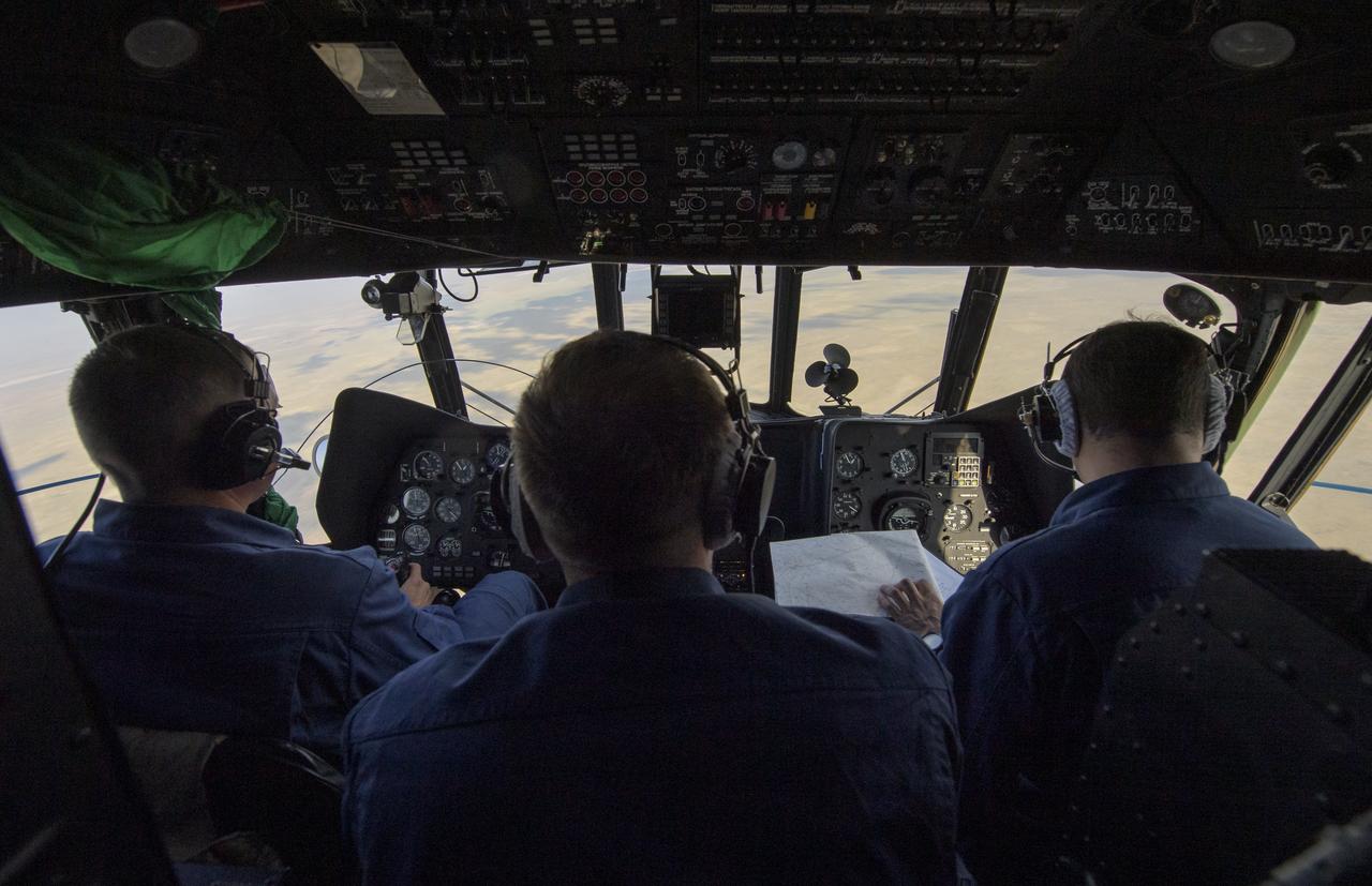 Russian helicopter pilots scan the horizon looking for the Soyuz MS-11 spacecraft as it lands with Expedition 59 crew members Anne McClain of NASA, David Saint-Jacques of the Canadian Space Agency, and Oleg Kononenko of Roscosmos, Tuesday, June 25, 2019 Kazakh time (June 24 Eastern time) near the town of Zhezkazgan, Kazakhstan. McClain, Saint-Jacques, and Kononenko are returning after 204 days in space where they served as members of the Expedition 58 and 59 crews onboard the International Space Station. Photo Credit: (NASA/Bill Ingalls)