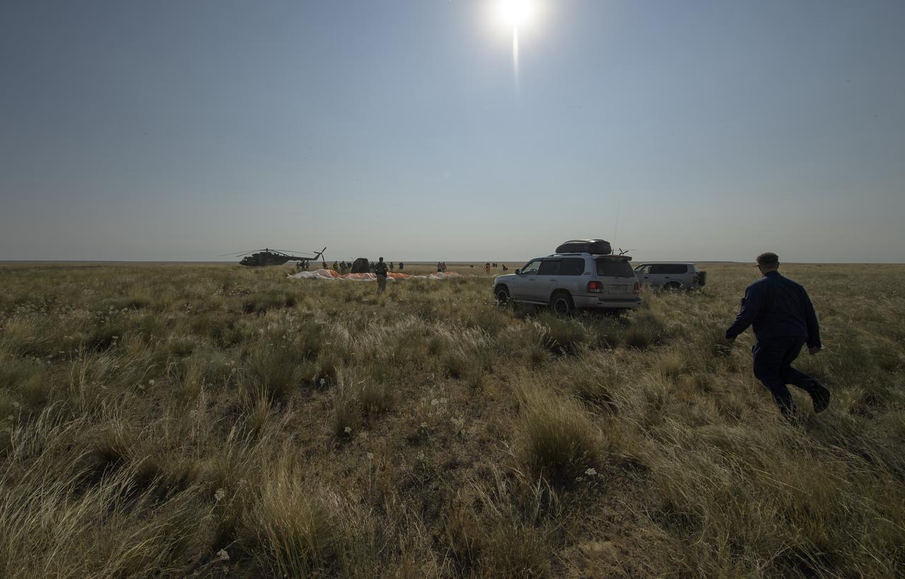 Russian Search and Rescue teams arrive at the Soyuz MS-11 spacecraft shortly after it landed in a remote area near the town of Zhezkazgan, Kazakhstan with Expedition 59 crew members Anne McClain of NASA, David Saint-Jacques of the Canadian Space Agency, and Oleg Kononenko of Roscosmos, Tuesday, June 25, 2019 Kazakh time (June 24 Eastern time). McClain, Saint-Jacques, and Kononenko are returning after 204 days in space where they served as members of the Expedition 58 and 59 crews onboard the International Space Station. Photo Credit: (NASA/Bill Ingalls)