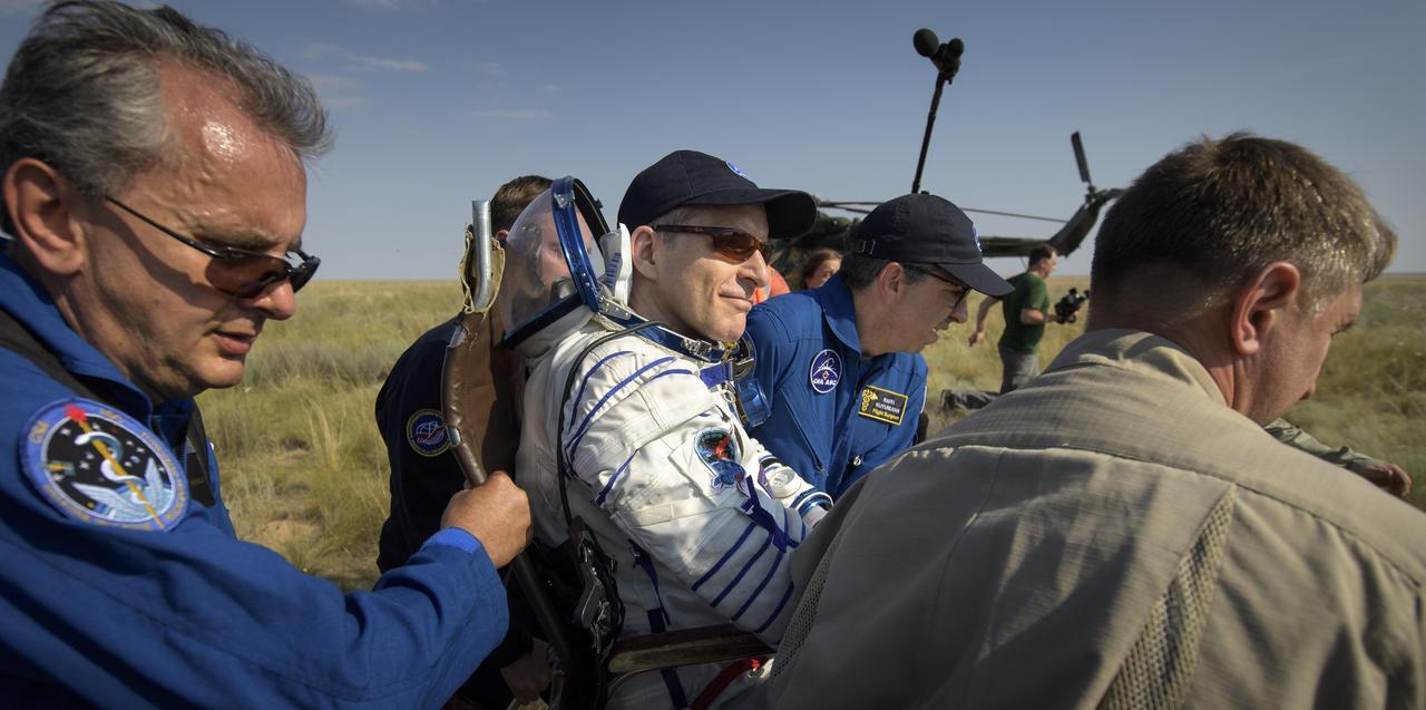 Expedition 59 Canadian Space Agency astronaut David Saint-Jacques is carried to a medical tent shortly after he, NASA astronaut Anne McClain, and Roscosmos cosmonaut Oleg Kononenko landed in their Soyuz MS-11 spacecraft near the town of Zhezkazgan, Kazakhstan on Tuesday, June 25, 2019 Kazakh time (June 24 Eastern time). McClain, Saint-Jacques, and Kononenko are returning after 204 days in space where they served as members of the Expedition 58 and 59 crews onboard the International Space Station. Photo Credit: (NASA/Bill Ingalls)