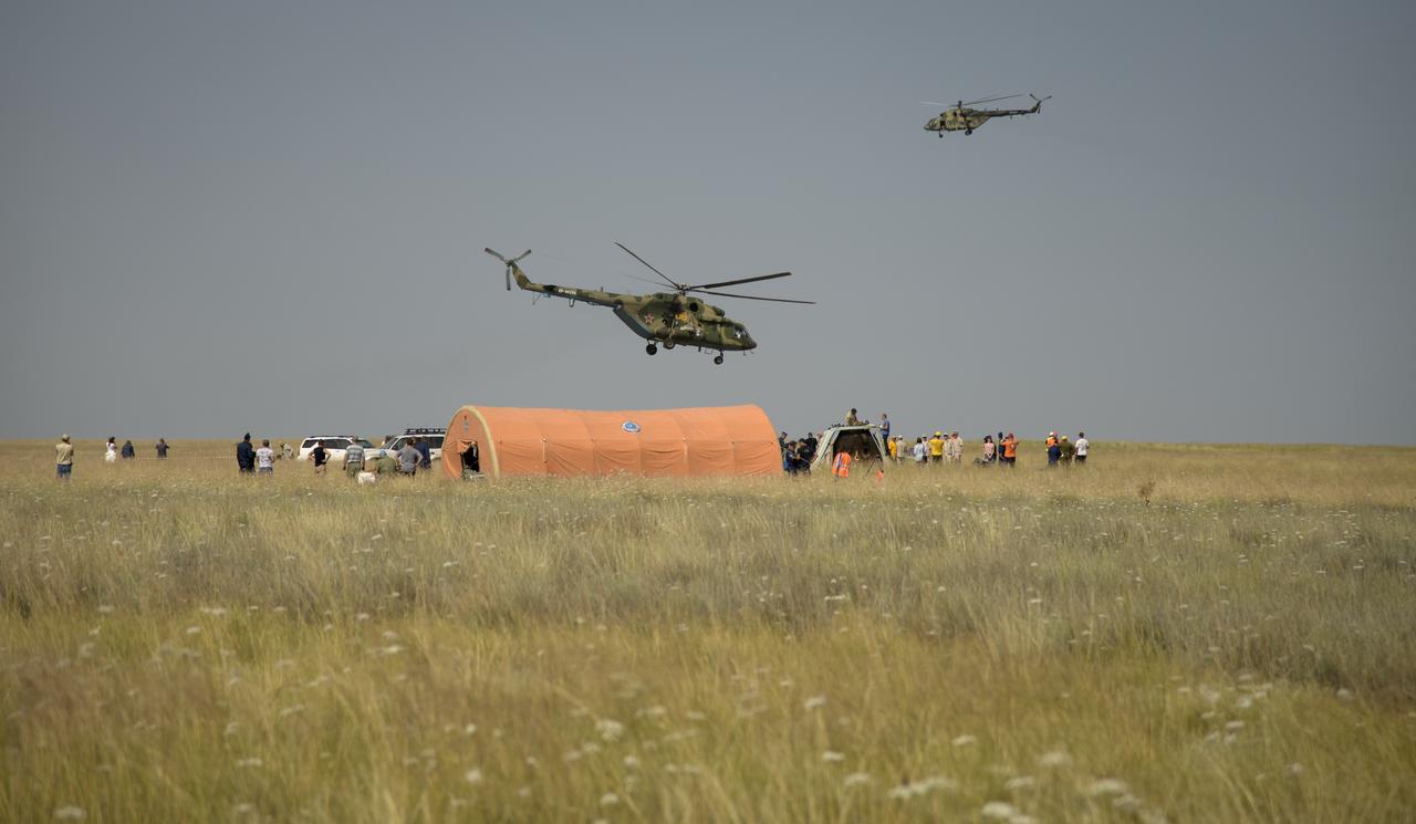 Russian support personnel work around the Soyuz MS-11 spacecraft shortly after it landed with Expedition 59 crew members Anne McClain of NASA, David Saint-Jacques of the Canadian Space Agency, and Oleg Kononenko of Roscosmos near the town of Zhezkazgan, Kazakhstan on Tuesday, June 25, 2019 Kazakh time (June 24 Eastern time). McClain, Saint-Jacques, and Kononenko are returning after 204 days in space where they served as members of the Expedition 58 and 59 crews onboard the International Space Station. Photo Credit: (NASA/Bill Ingalls)