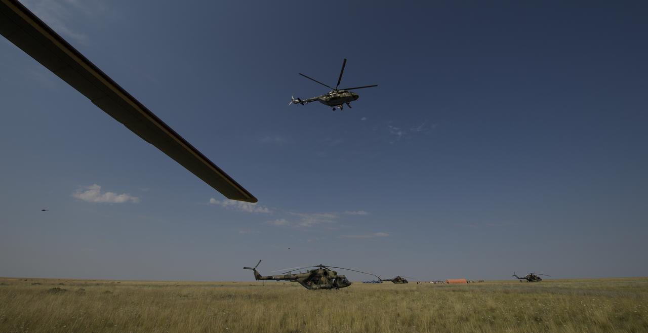 Russian support personnel work around the Soyuz MS-11 spacecraft shortly after it landed with Expedition 59 crew members Anne McClain of NASA, David Saint-Jacques of the Canadian Space Agency, and Oleg Kononenko of Roscosmos near the town of Zhezkazgan, Kazakhstan on Tuesday, June 25, 2019 Kazakh time (June 24 Eastern time). McClain, Saint-Jacques, and Kononenko are returning after 204 days in space where they served as members of the Expedition 58 and 59 crews onboard the International Space Station. Photo Credit: (NASA/Bill Ingalls)