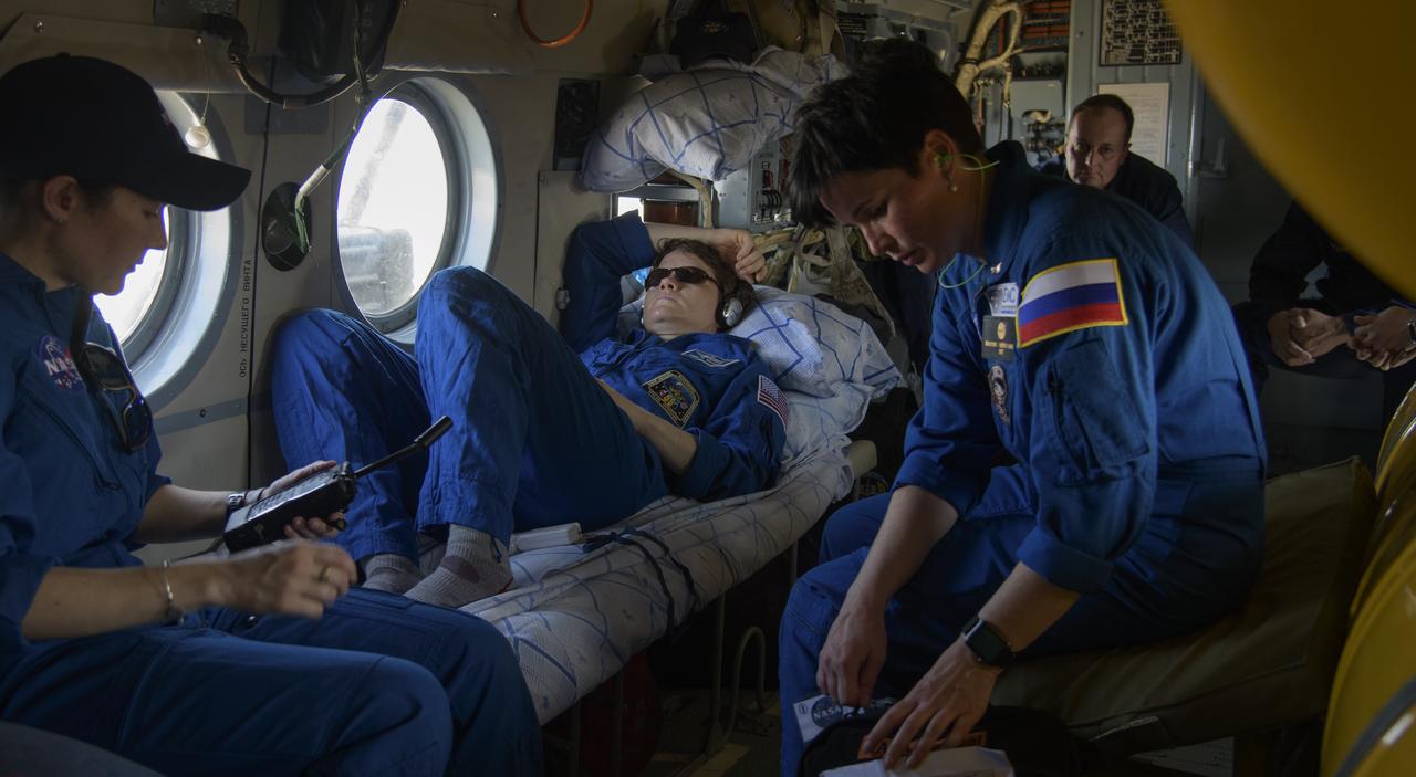 Expedition 59 NASA astronaut Anne McClain rests onboard a helicopter during a flight from the Soyuz MS-11 spacecraft landing site to Karaganda, Kazakhstan as NASA Flight Surgeon Natacha Chough, left, and Russian Nurse Raksana Batsmanova, right, look after her, Tuesday, June 25, 2019. McClain, Canadian Space Agency astronaut David Saint-Jacques, and Roscosmos cosmonaut Oleg Kononenko landed in their Soyuz MS-11 spacecraft in a remote area near Zhezkazgan, Kazakhstan after 204 days in space where they served as members of the Expedition 58 and 59 crews onboard the International Space Station. Photo Credit: (NASA/Bill Ingalls)