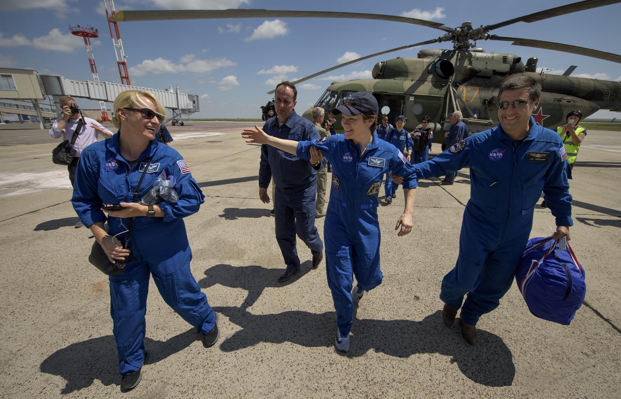 Expedition 59 NASA astronaut Anne McClain, center, assisted by NASA ISS Deputy Program Manager Joel Montalbano, right, reaches out to greet NASA astronaut and Director of Operations, Star City, Russia, Kate Rubins as she arrives at the Karaganda Airport in Kazakhstan Tuesday, June 25, 2019. McClain, Canadian Space Agency astronaut David Saint-Jacques, and Roscosmos cosmonaut Oleg Kononenko landed earlier in the day in their Soyuz MS-11 spacecraft in a remote area near Zhezkazgan, Kazakhstan after 204 days in space where they served as members of the Expedition 58 and 59 crews onboard the International Space Station. Photo Credit: (NASA/Bill Ingalls)