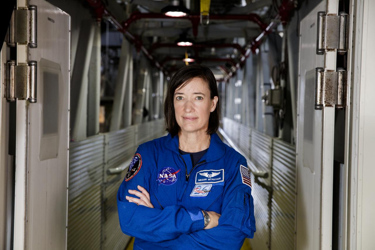 NASA astronaut Megan McArthur poses for a portrait on the Crew Access Arm of the mobile launcher, Tuesday, June 25, 2019 inside the Vehicle Assembly Building at NASA's Kennedy Space Center in Florida. Photo Credit: (NASA/Joel Kowsky)