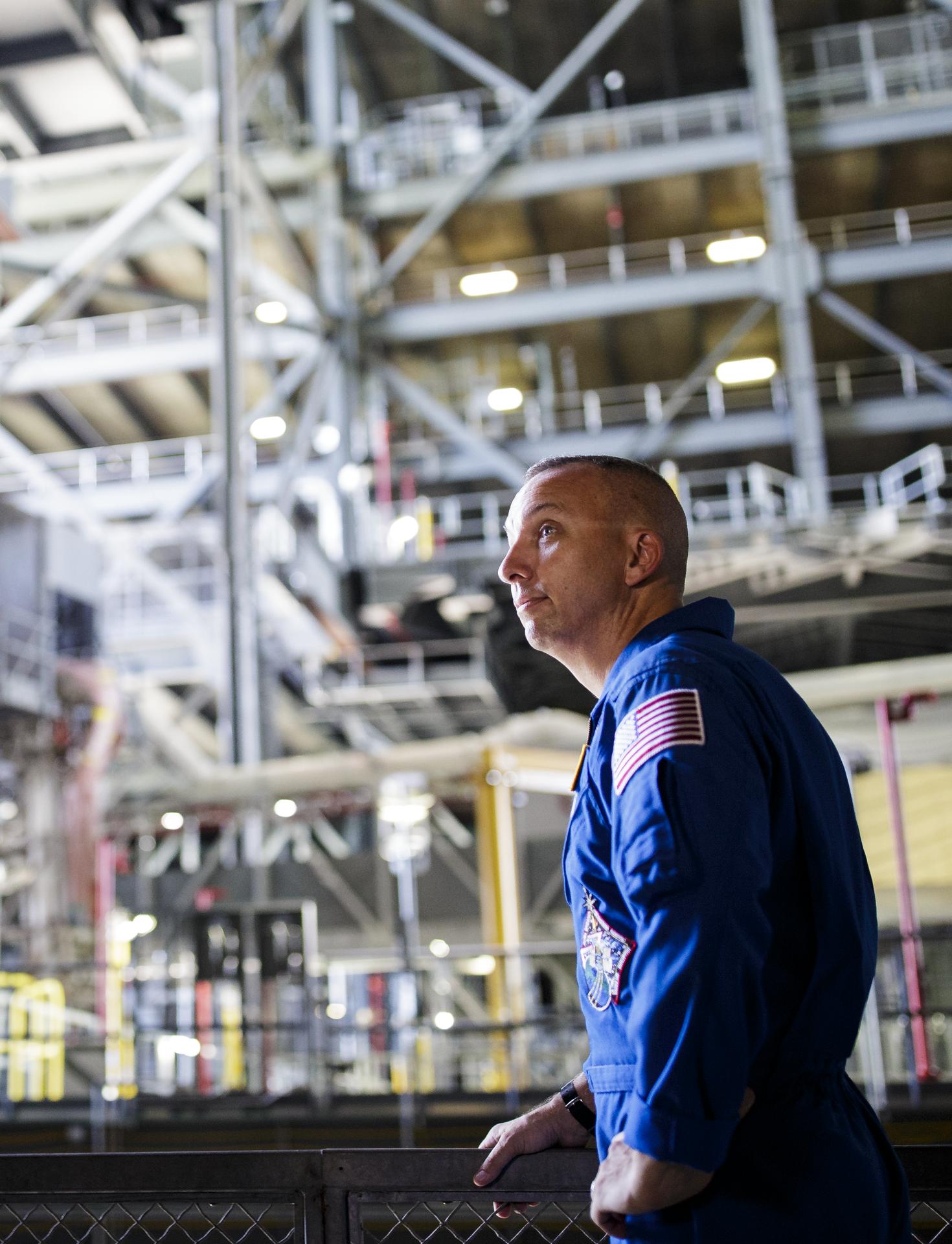 NASA astronaut Randy Bresnik, wearing a blue flight suit, is seen inside the Vehicle Assemby Building, Tuesday, June 25, 2019 at NASA's Kennedy Space Center in Florida. Photo Credit: (NASA/Joel Kowsky)