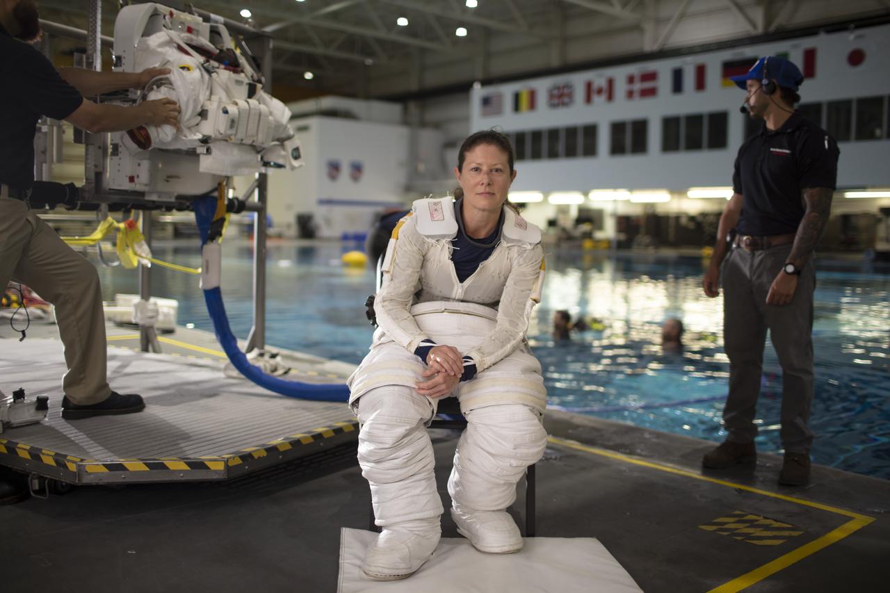 NASA astronaut Tracy Caldwell Dyson pauses for a portrait while donning her spacesuit and going under water in the Neutral Buoyancy Lab, Monday, July 8, 2019 at NASA's Johnson Space Center in Houston, Texas. Photo Credit: (NASA/Bill Ingalls)