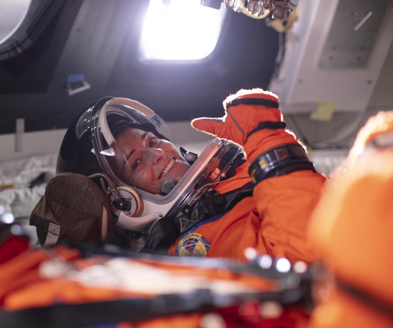 NASA astronaut Nicole Mann gives a thumbs up from inside the Orion mockup, Wednesday, July 10, 2019 at NASA's Johnson Space Center in Houston, Texas. Photo Credit: (NASA/Bill Ingalls)