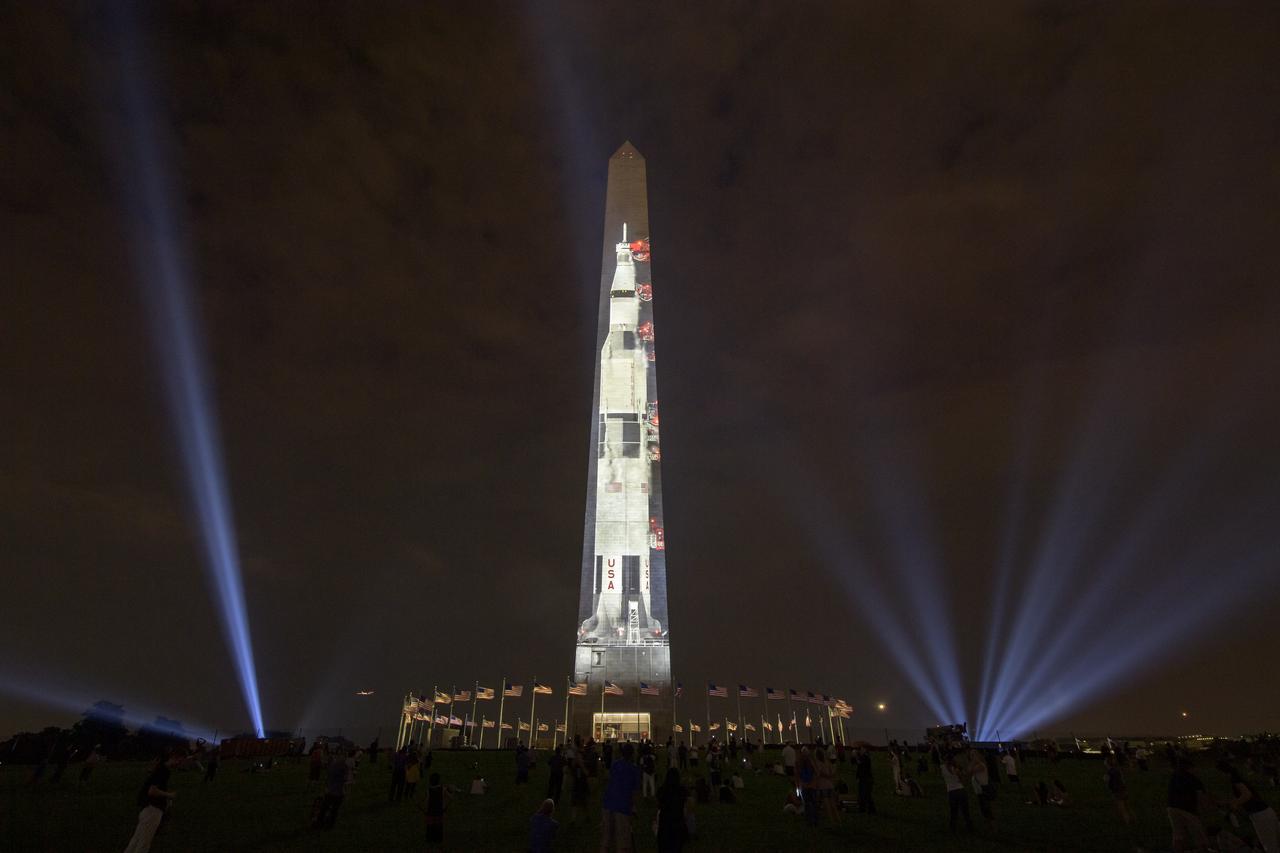 A full-sized, 363-foot Saturn V rocket is projected onto the east face of the Washington Monument 50 years to the day after astronauts Neil Armstrong, Michael Collins, and Buzz Aldrin launched on Apollo 11, the first mission to land astronauts on the Moon, Tuesday, July 16, 2019. On Friday, July 19, and Saturday, July 20, a special 17-minute show, “Apollo 50: Go for the Moon” will combine full-motion projection-mapping artwork on the monument and archival footage to recreate the launch of Apollo 11 and tell the story of the first moon landing. Photo Credit: (NASA/Bill Ingalls)