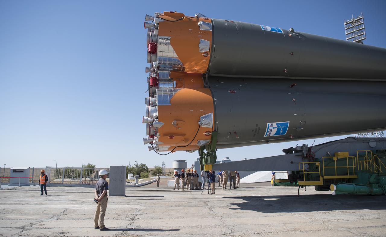 Workers watch as the Soyuz rocket approaches the launch pad after being rolled out by train, Thursday, July 18, 2019 at the Baikonur Cosmodrome in Kazakhstan. Expedition 60 Soyuz Commander Alexander Skvortsov of Roscosmos, flight engineer Andrew Morgan of NASA, and flight engineer Luca Parmitano of ESA (European Space Agency) are scheduled to launch aboard their Soyuz MS-13 spacecraft at 12:28 p.m. Eastern time (9:28 p.m. Baikonur time) , on Saturday, July 20. Photo Credit: (NASA/Joel Kowsky)