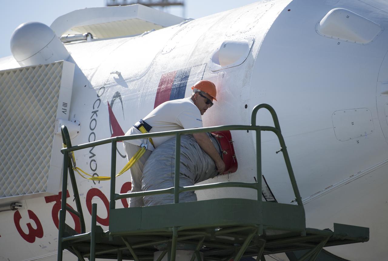 Workers are seen as they prepare the Soyuz rocket to be raised into a vertical position at the launch pad, Thursday, July 18, 2019 at the Baikonur Cosmodrome in Kazakhstan. Expedition 60 Soyuz Commander Alexander Skvortsov of Roscosmos, flight engineer Andrew Morgan of NASA, and flight engineer Luca Parmitano of ESA (European Space Agency) are scheduled to launch aboard their Soyuz MS-13 spacecraft at 12:28 p.m. Eastern time (9:28 p.m. Baikonur time) , on Saturday, July 20. Photo Credit: (NASA/Joel Kowsky)