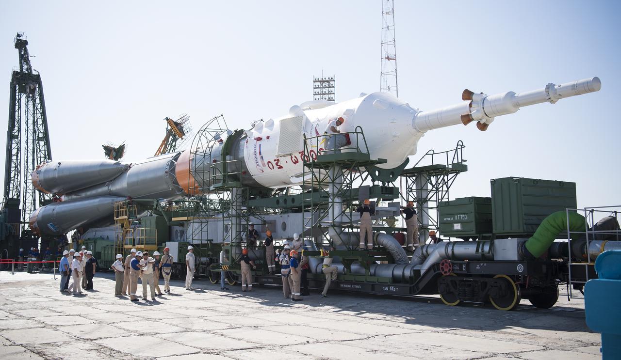 Workers are seen as they prepare the Soyuz rocket to be raised into a vertical position at the launch pad, Thursday, July 18, 2019 at the Baikonur Cosmodrome in Kazakhstan. Expedition 60 Soyuz Commander Alexander Skvortsov of Roscosmos, flight engineer Andrew Morgan of NASA, and flight engineer Luca Parmitano of ESA (European Space Agency) are scheduled to launch aboard their Soyuz MS-13 spacecraft at 12:28 p.m. Eastern time (9:28 p.m. Baikonur time) , on Saturday, July 20. Photo Credit: (NASA/Joel Kowsky)