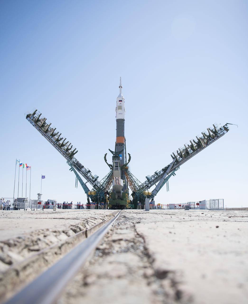 The Soyuz rocket is see on the launch pad as the service structure arms are closed around it, Thursday, July 18, 2019 at the Baikonur Cosmodrome in Kazakhstan. Expedition 60 Soyuz Commander Alexander Skvortsov of Roscosmos, flight engineer Andrew Morgan of NASA, and flight engineer Luca Parmitano of ESA (European Space Agency) are scheduled to launch aboard their Soyuz MS-13 spacecraft at 12:28 p.m. Eastern time (9:28 p.m. Baikonur time) , on Saturday, July 20. Photo Credit: (NASA/Joel Kowsky)