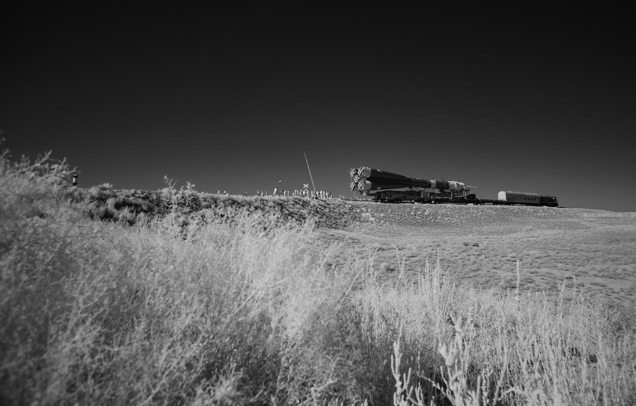 In this black and white infrared image, the Soyuz rocket is seen as it transported to the launch pad by train, Thursday, July 18, 2019 at the Baikonur Cosmodrome in Kazakhstan. Expedition 60 Soyuz Commander Alexander Skvortsov of Roscosmos, flight engineer Andrew Morgan of NASA, and flight engineer Luca Parmitano of ESA (European Space Agency) are scheduled to launch aboard their Soyuz MS-13 spacecraft at 12:28 p.m. Eastern time (9:28 p.m. Baikonur time), on Saturday, July 20. Photo Credit: (NASA/Joel Kowsky)