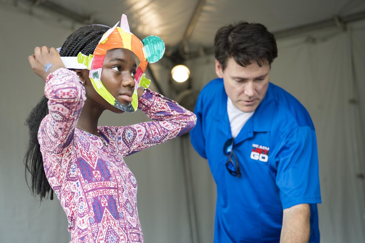 A visitor explores the Ready Jet Go exhibit at the Apollo 11 50th Anniversary celebration on the National Mall, Thursday, July 18, 2019 in Washington. Apollo 11 was the first mission to land astronauts on the Moon and launched on July 16, 1969 with astronauts Neil Armstrong, Michael Collins, and Buzz Aldrin. Photo Credit: (NASA/Aubrey Gemignani)