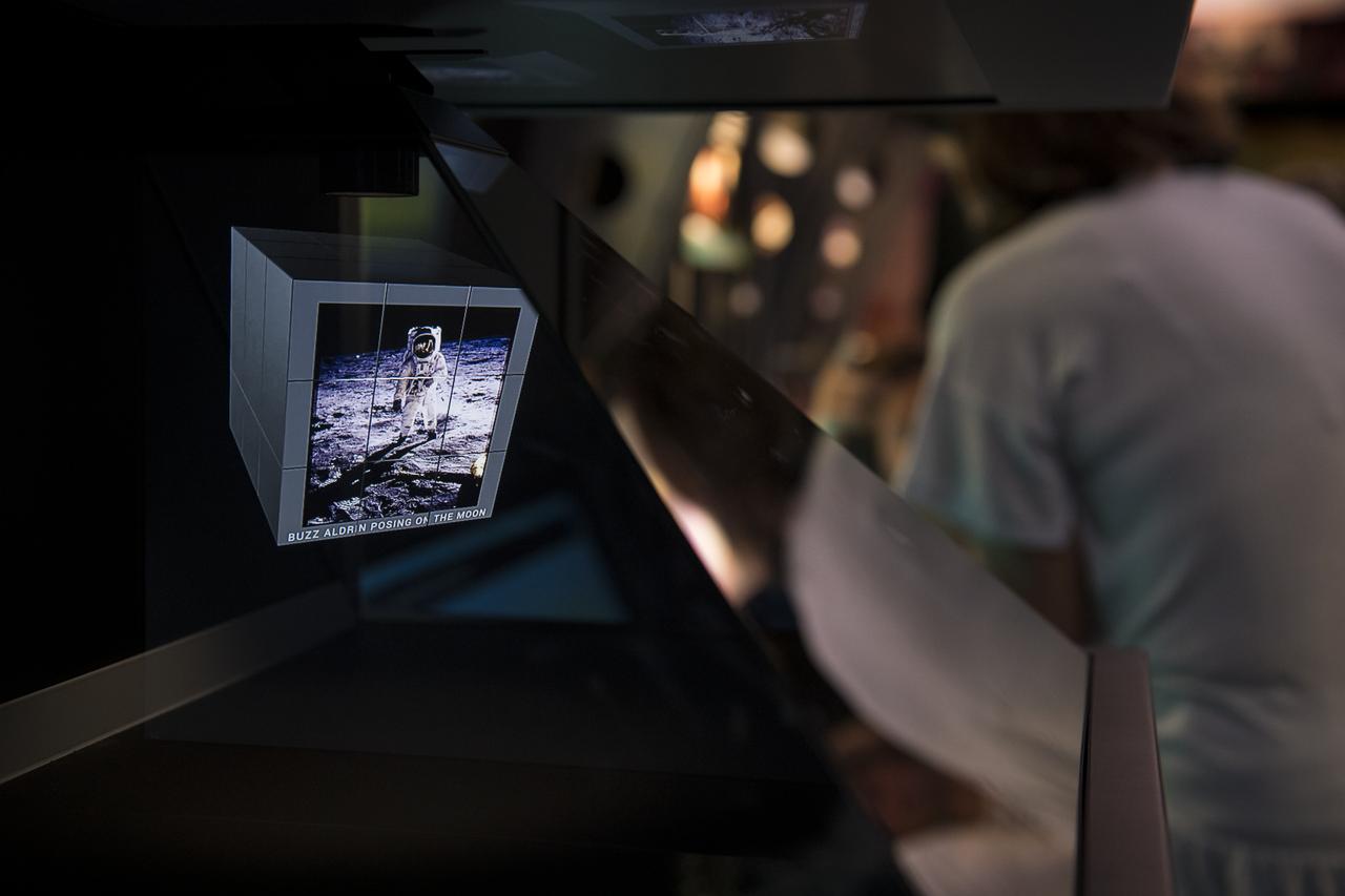 A visitor explores the Journey to Tomorrow exhibit at the Apollo 11 50th Anniversary celebration on the National Mall, Thursday, July 18, 2019 in Washington. Apollo 11 was the first mission to land astronauts on the Moon and launched on July 16, 1969 with astronauts Neil Armstrong, Michael Collins, and Buzz Aldrin. Photo Credit: (NASA/Aubrey Gemignani)