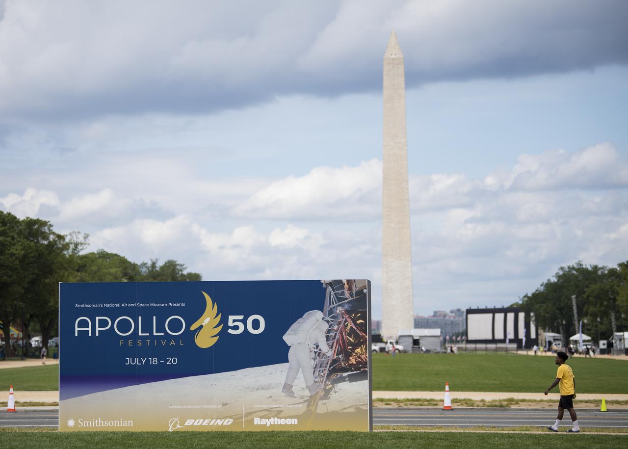 A visitor explores the exhibit at the Apollo 11 50th Anniversary celebration on the National Mall, Thursday, July 18, 2019 in Washington. Apollo 11 was the first mission to land astronauts on the Moon and launched on July 16, 1969 with astronauts Neil Armstrong, Michael Collins, and Buzz Aldrin. Photo Credit: (NASA/Aubrey Gemignani)