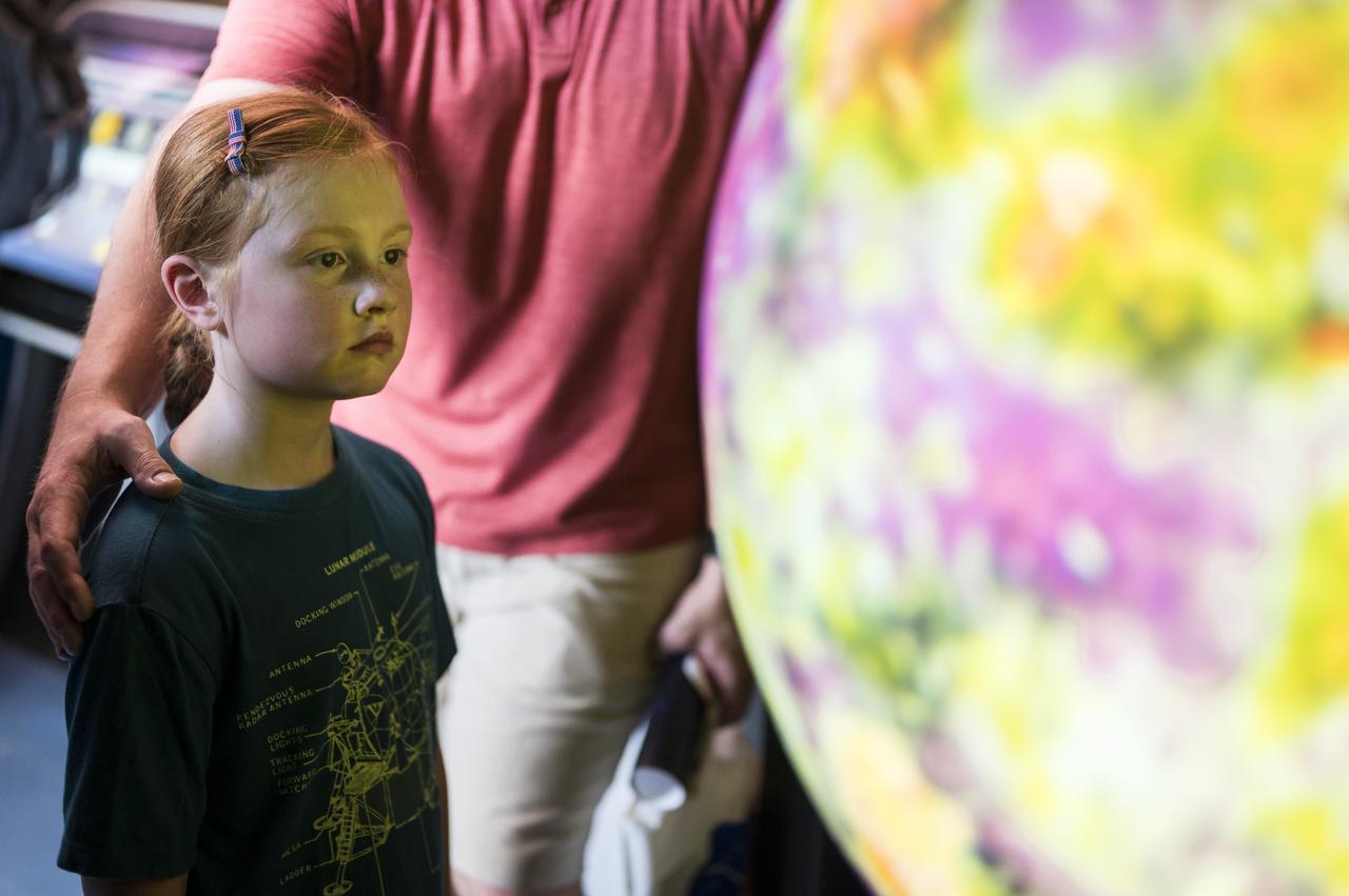 A visitor explores the Journey to Tomorrow exhibit at the Apollo 11 50th Anniversary celebration on the National Mall, Thursday, July 18, 2019 in Washington. Apollo 11 was the first mission to land astronauts on the Moon and launched on July 16, 1969 with astronauts Neil Armstrong, Michael Collins, and Buzz Aldrin. Photo Credit: (NASA/Aubrey Gemignani)
