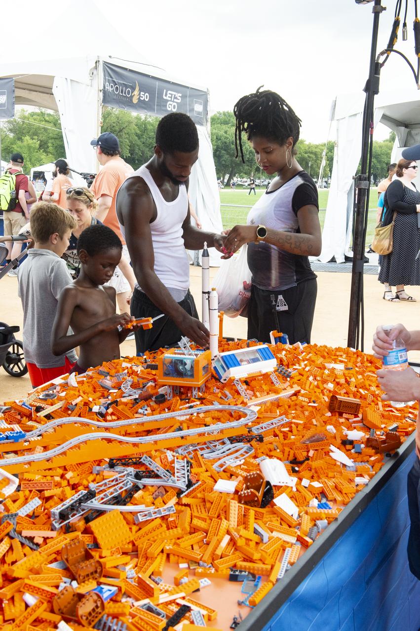 Visitors explore the LEGO exhibit at the Apollo 11 50th Anniversary celebration on the National Mall, Thursday, July 18, 2019 in Washington. Apollo 11 was the first mission to land astronauts on the Moon and launched on July 16, 1969 with astronauts Neil Armstrong, Michael Collins, and Buzz Aldrin. Photo Credit: (NASA/Connie Moore)