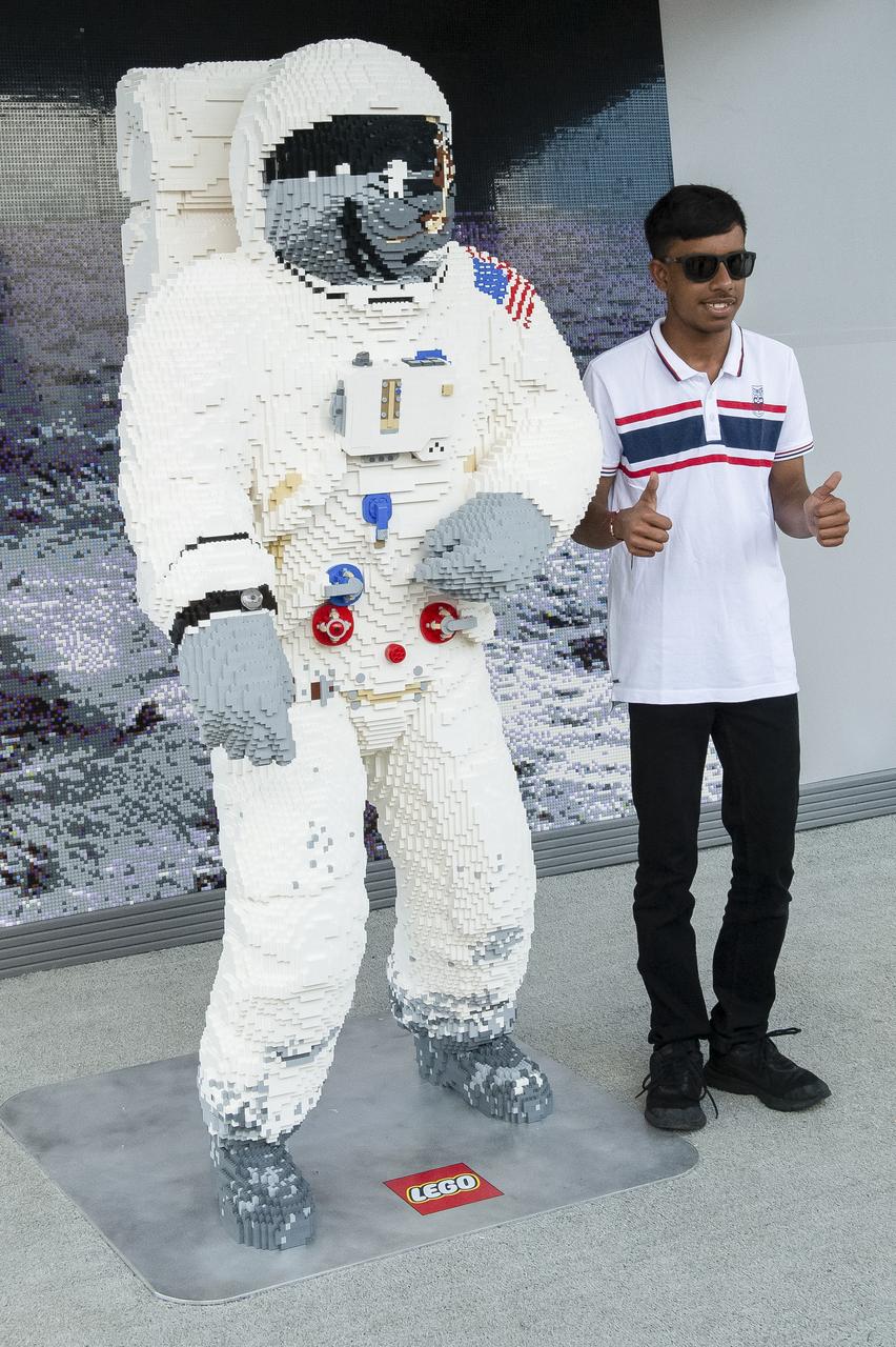 A visitor poses for a photo with an astronaut made of LEGOs at the LEGO exhibit at the Apollo 11 50th Anniversary celebration on the National Mall, Thursday, July 18, 2019 in Washington. Apollo 11 was the first mission to land astronauts on the Moon and launched on July 16, 1969 with astronauts Neil Armstrong, Michael Collins, and Buzz Aldrin. Photo Credit: (NASA/Connie Moore)