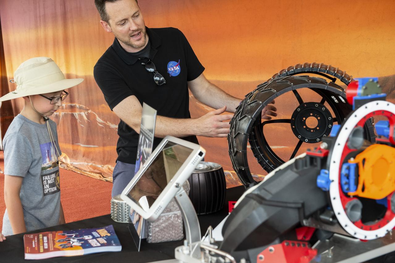 Visitors learn about rover tires at the Apollo 11 50th Anniversary celebration on the National Mall, Thursday, July 18, 2019 in Washington. Apollo 11 was the first mission to land astronauts on the Moon and launched on July 16, 1969 with astronauts Neil Armstrong, Michael Collins, and Buzz Aldrin. Photo Credit: (NASA/Connie Moore)