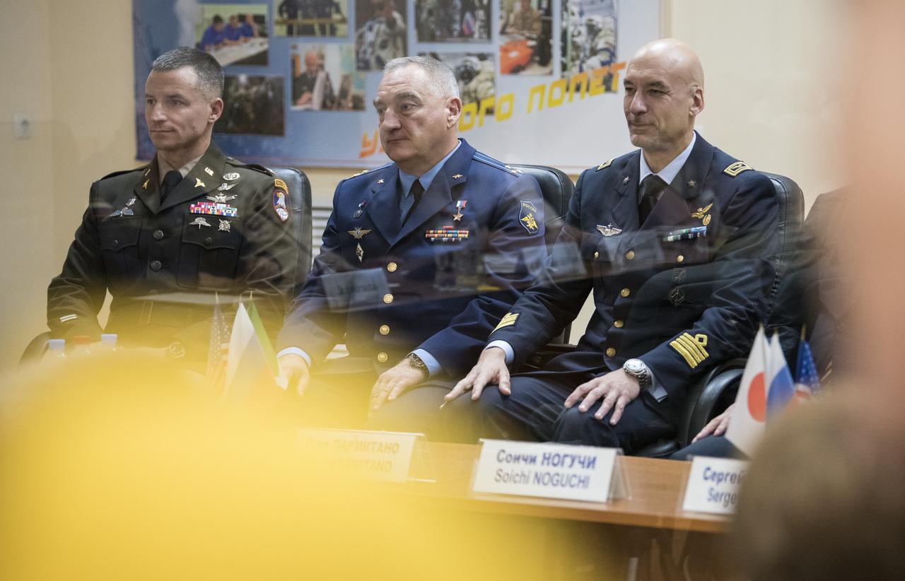 Expedition 60 flight engineer Andrew Morgan of NASA, left, Soyuz Commander Alexander Skvortsov of Roscosmos, center, and flight engineer Luca Parmitano of ESA (European Space Agency), right are seen during the State Commission meeting to approve the Soyuz launch of Expedition 60 to the International Space Station, Friday, July 19, 2019 at the Cosmonaut Hotel in Baikonur, Kazakhstan. Morgan, Skvortsov, and Parmitano are scheduled to launch to the International Space Station aboard the Soyuz MS-13 spacecraft on Saturday, July 20. Photo Credit: (NASA/Joel Kowsky)