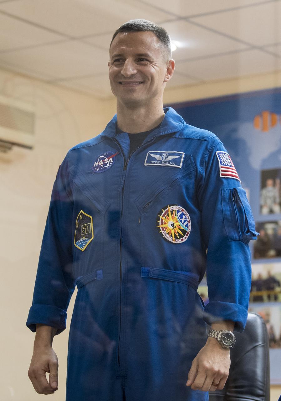 Expedition 60 flight engineer Andrew Morgan of NASA is introduced during a press conference, Friday, July 19, 2019 at the Cosmonaut Hotel in Baikonur, Kazakhstan. Expedition 60 Soyuz Commander Alexander Skvortsov of Roscosmos, flight engineer Andrew Morgan of NASA, and flight engineer Luca Parmitano of ESA (European Space Agency) are scheduled to launch to the International Space Station aboard the Soyuz MS-13 spacecraft at 12:28 p.m. Eastern time (9:28 p.m. Baikonur time) on Saturday, July 20. Photo Credit: (NASA/Joel Kowsky)